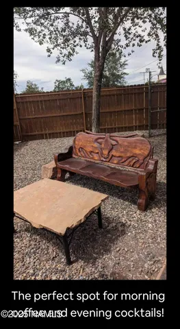 a view of a roof deck with wooden fence and trees
