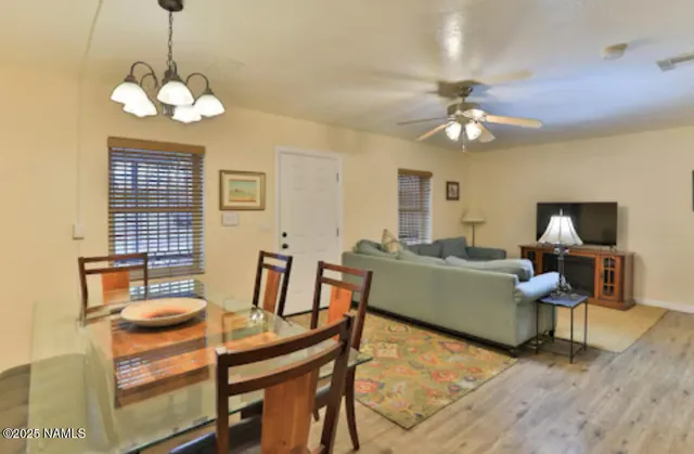 a view of a dining room with furniture and chandelier