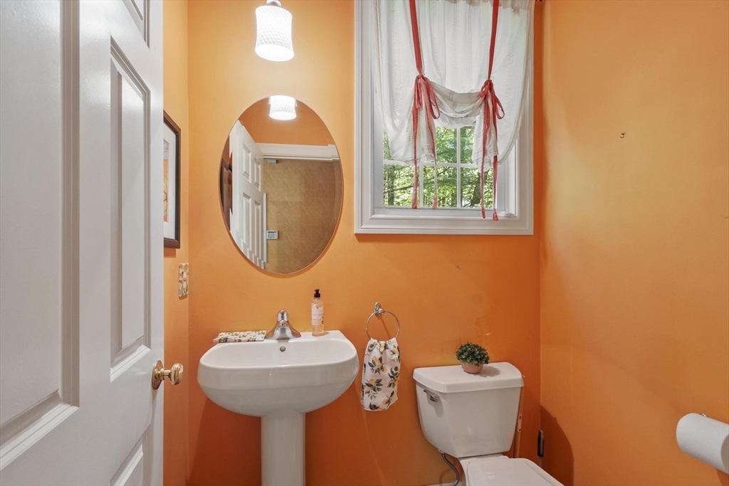 4 Forest Street Georgetown, MA 01833 - Photo 16 of 37 a bathroom with a toilet sink and mirror