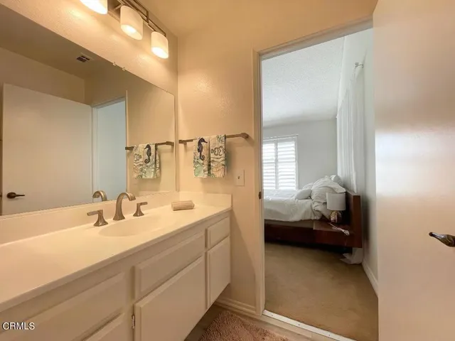 a en suite bathroom with double sink and a mirror
