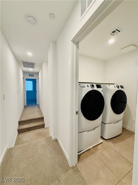 3219 Timorasso Avenue Henderson, NV 89044 - Photo 12 of 27 Laundry room featuring light colored carpet, recessed lighting, washer and clothes dryer, and light tile patterned floors
