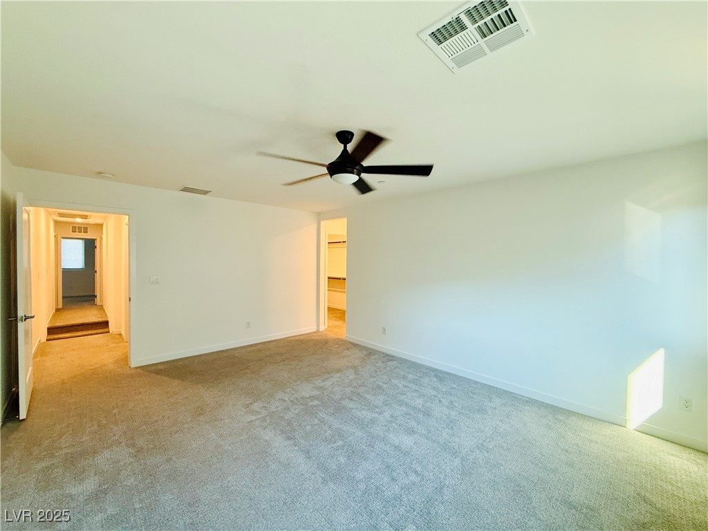 3219 Timorasso Avenue Henderson, NV 89044 - Photo 15 of 27 Unfurnished bedroom with light colored carpet and a ceiling fan