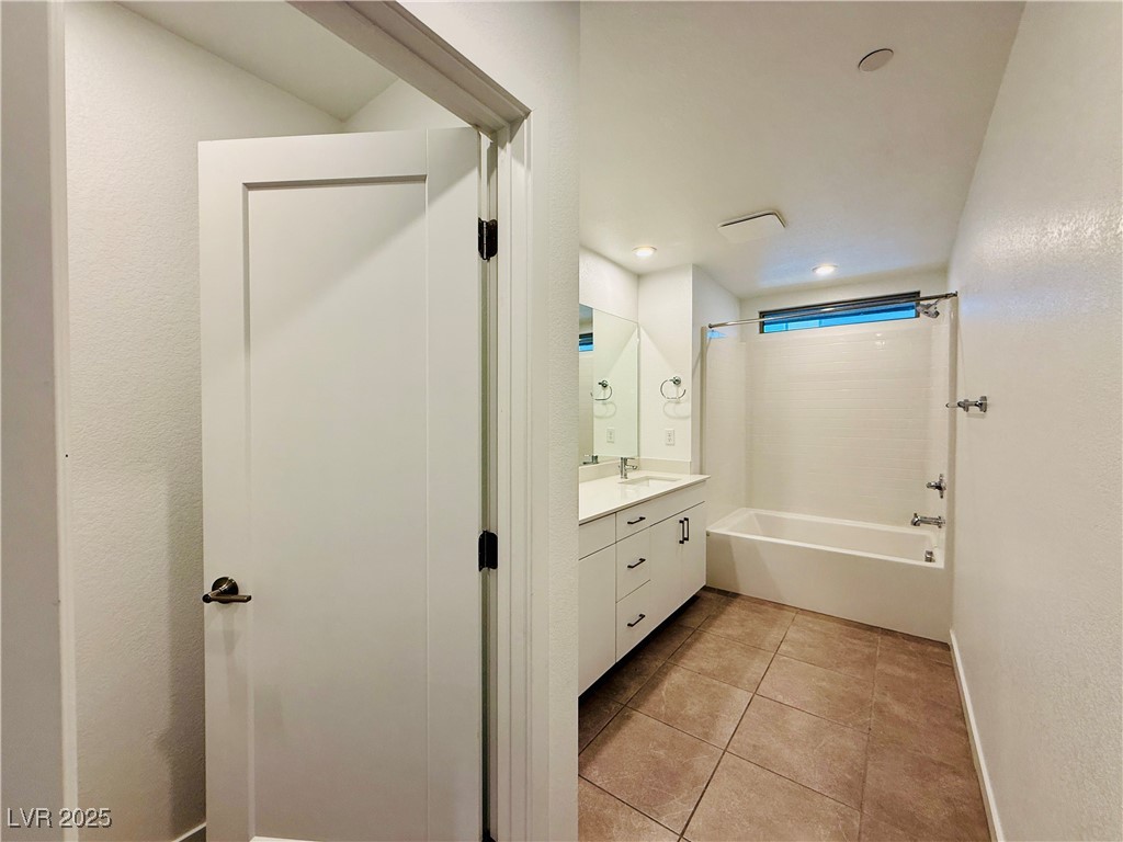 3219 Timorasso Avenue Henderson, NV 89044 - Photo 24 of 27 Full bath with shower combination, light tile patterned floors, vanity, recessed lighting, and a textured wall