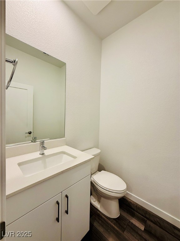 3219 Timorasso Avenue Henderson, NV 89044 - Photo 8 of 27 Bathroom with vanity, dark wood-style floors, and a textured wall