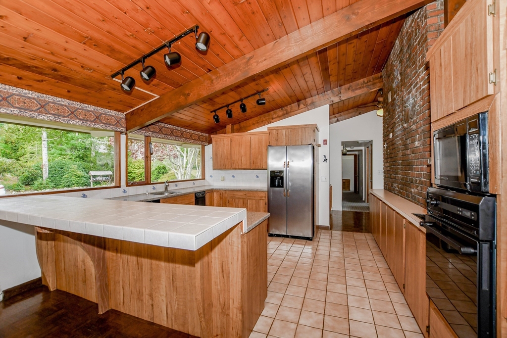 15 Arrowhead Lane Marion, MA 02738 - Photo 12 of 42 a kitchen with stainless steel appliances granite countertop a sink and wooden cabinets