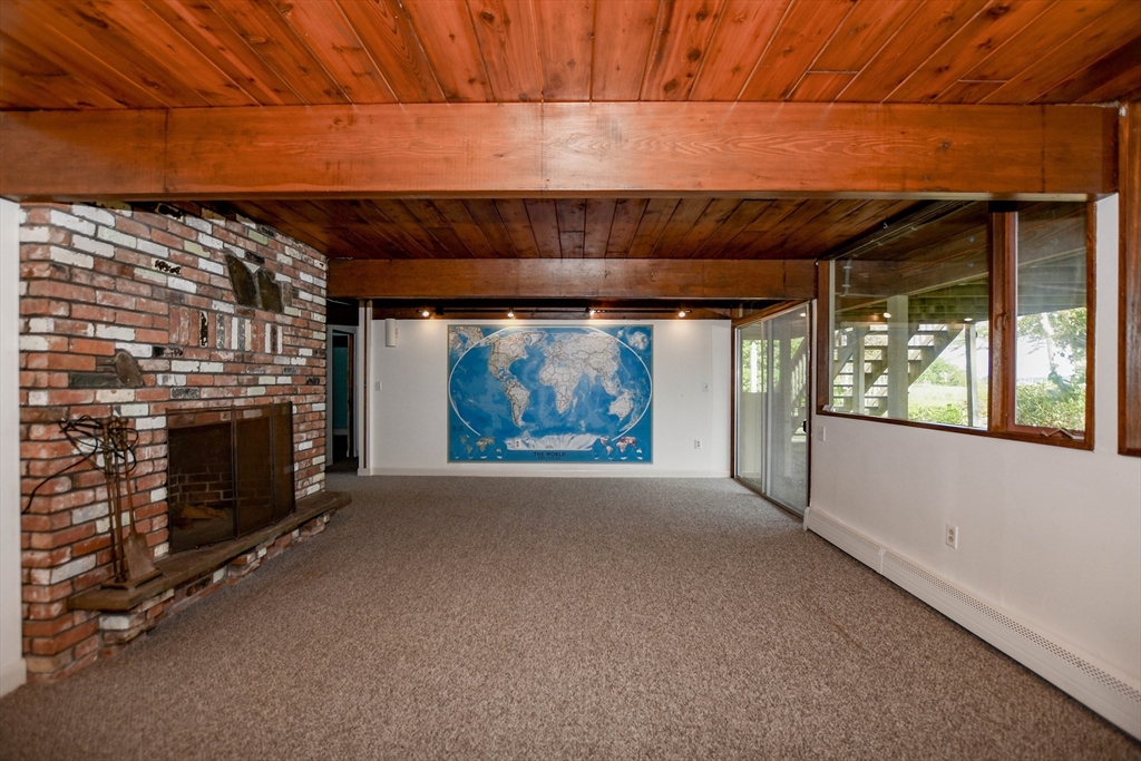 15 Arrowhead Lane Marion, MA 02738 - Photo 29 of 42 a view of an empty room with a fireplace and a window