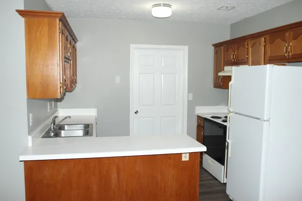 a kitchen with stainless steel appliances a refrigerator and a stove top oven