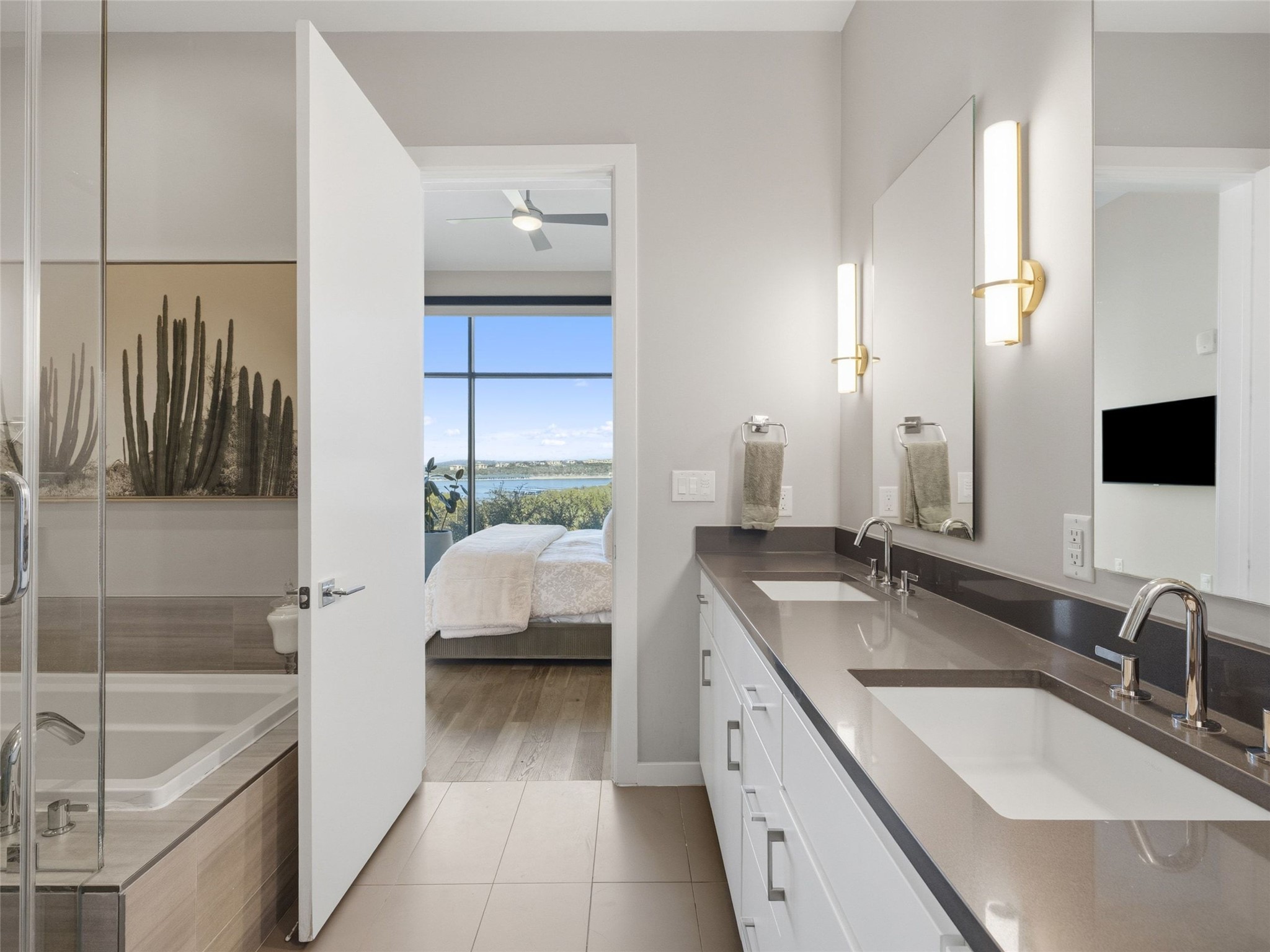 5921 Hiline Road, Unit 1303 Austin, TX 78734 - Photo 22 of 37 a en suite bathroom with a granite countertop tub sink and mirror