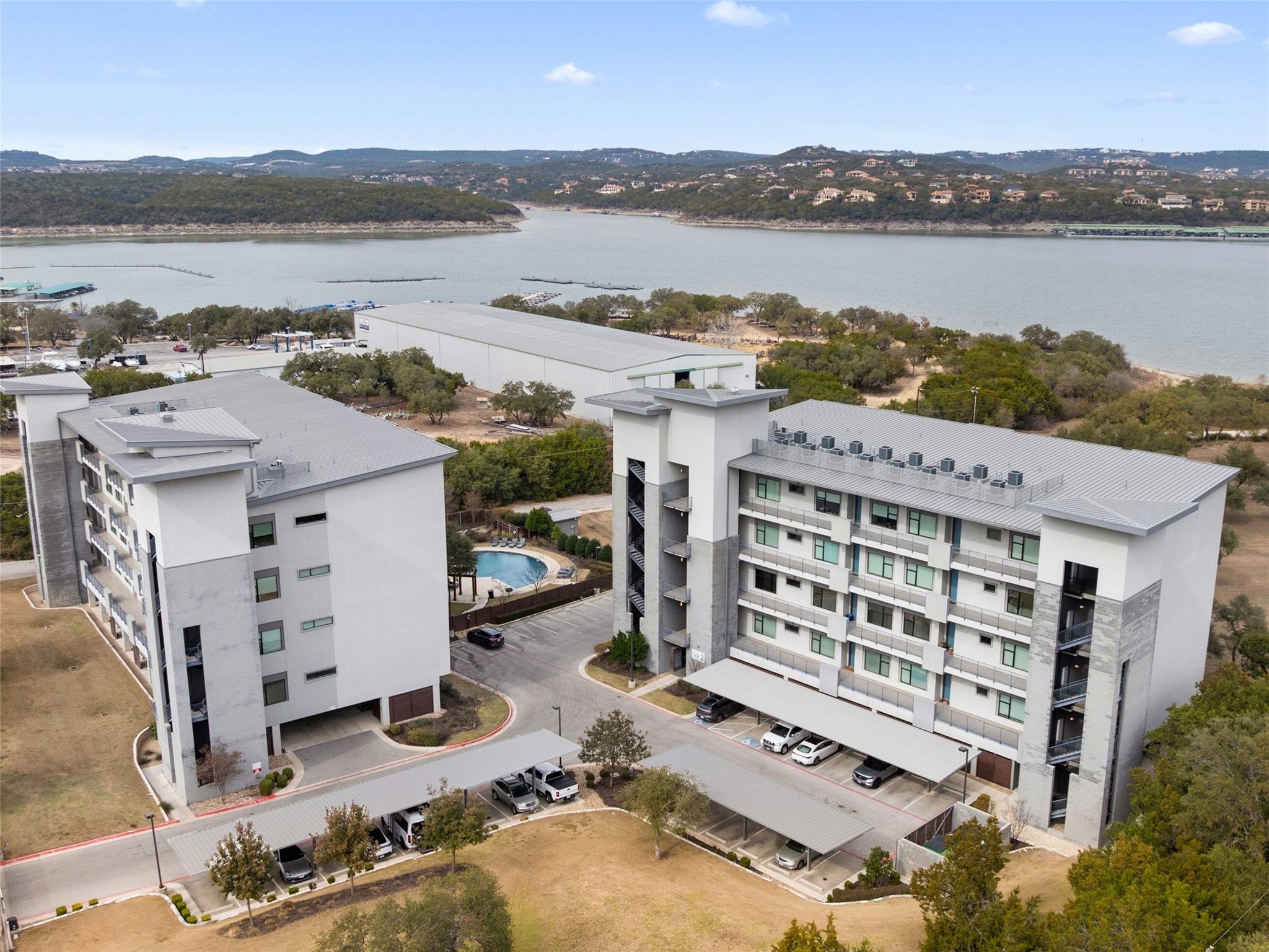 5921 Hiline Road, Unit 1303 Austin, TX 78734 - Photo 32 of 37 a view of a lake with building in front of it