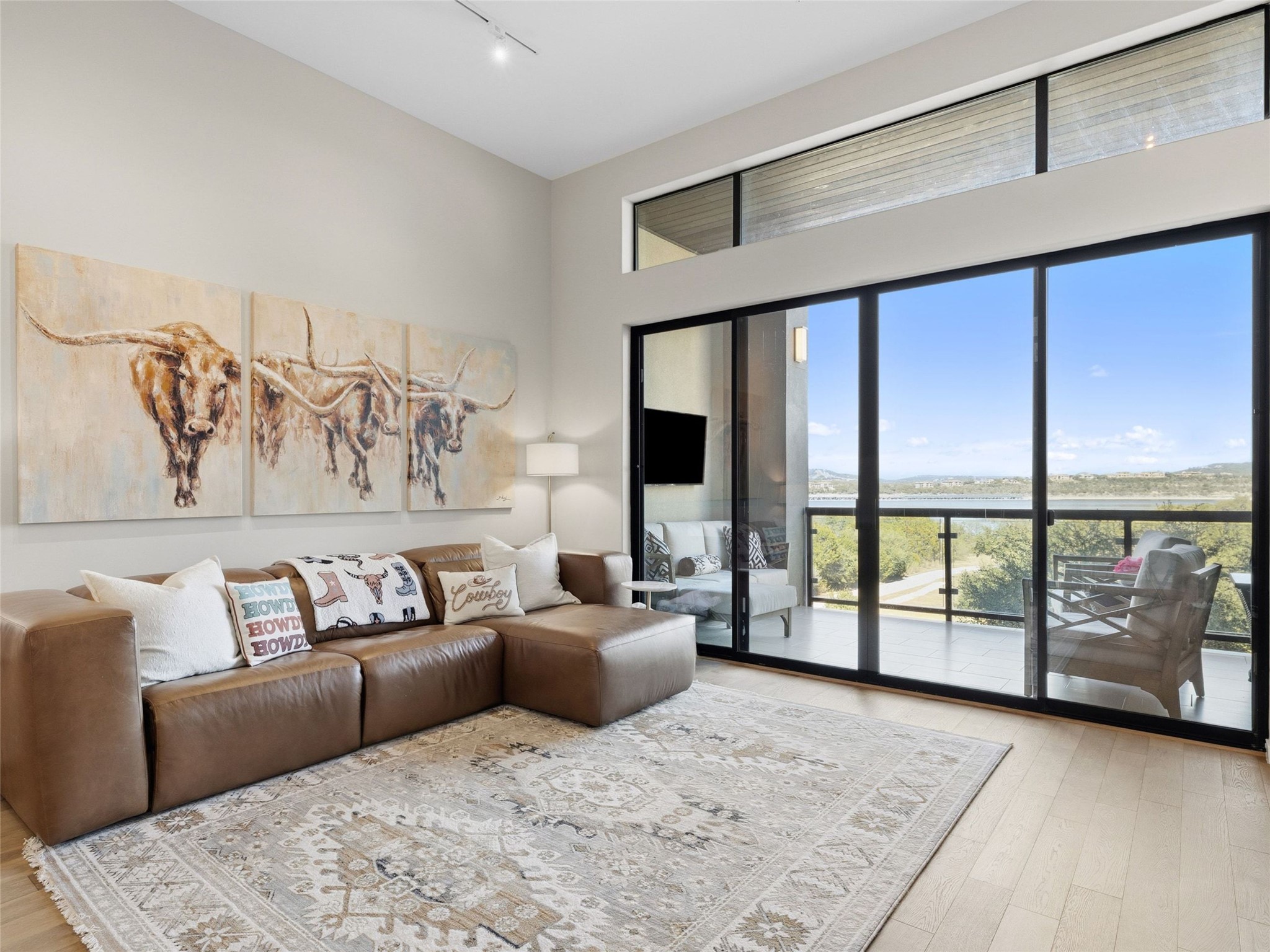 5921 Hiline Road, Unit 1303 Austin, TX 78734 - Photo 4 of 37 a living room with furniture and a floor to ceiling window