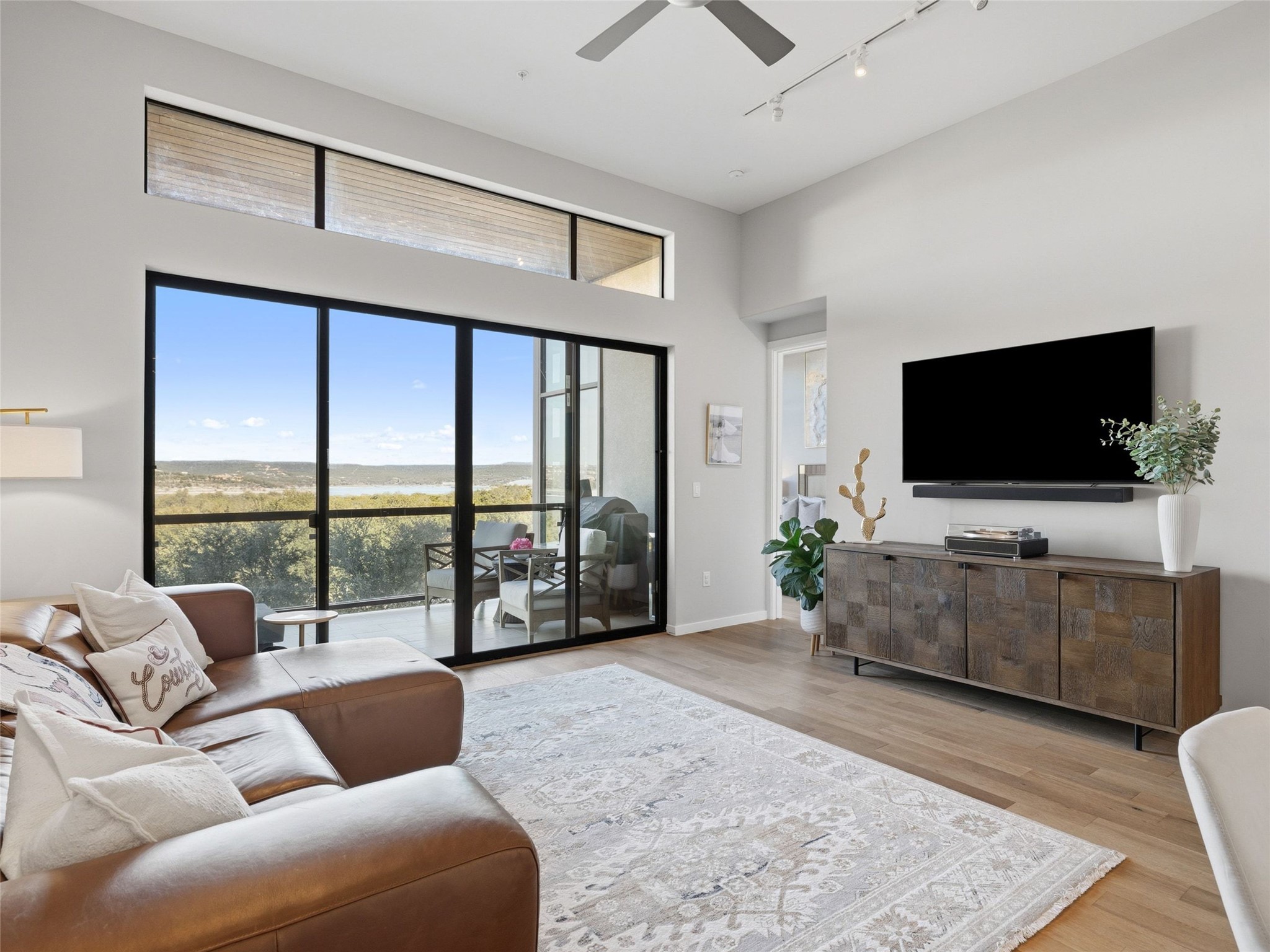 5921 Hiline Road, Unit 1303 Austin, TX 78734 - Photo 5 of 37 a living room with furniture and a flat screen tv