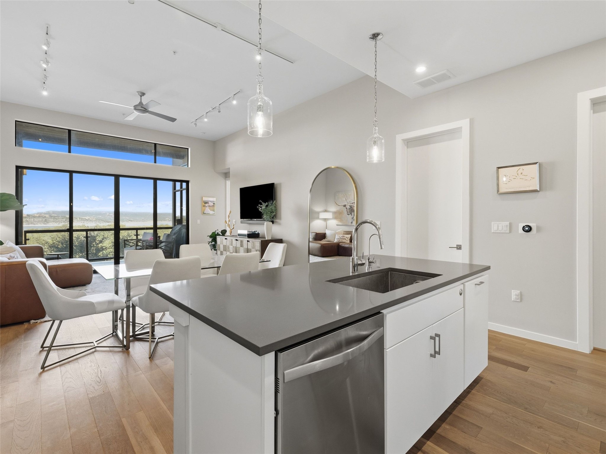 5921 Hiline Road, Unit 1303 Austin, TX 78734 - Photo 37 of 37 a kitchen with a table chairs and wooden floor