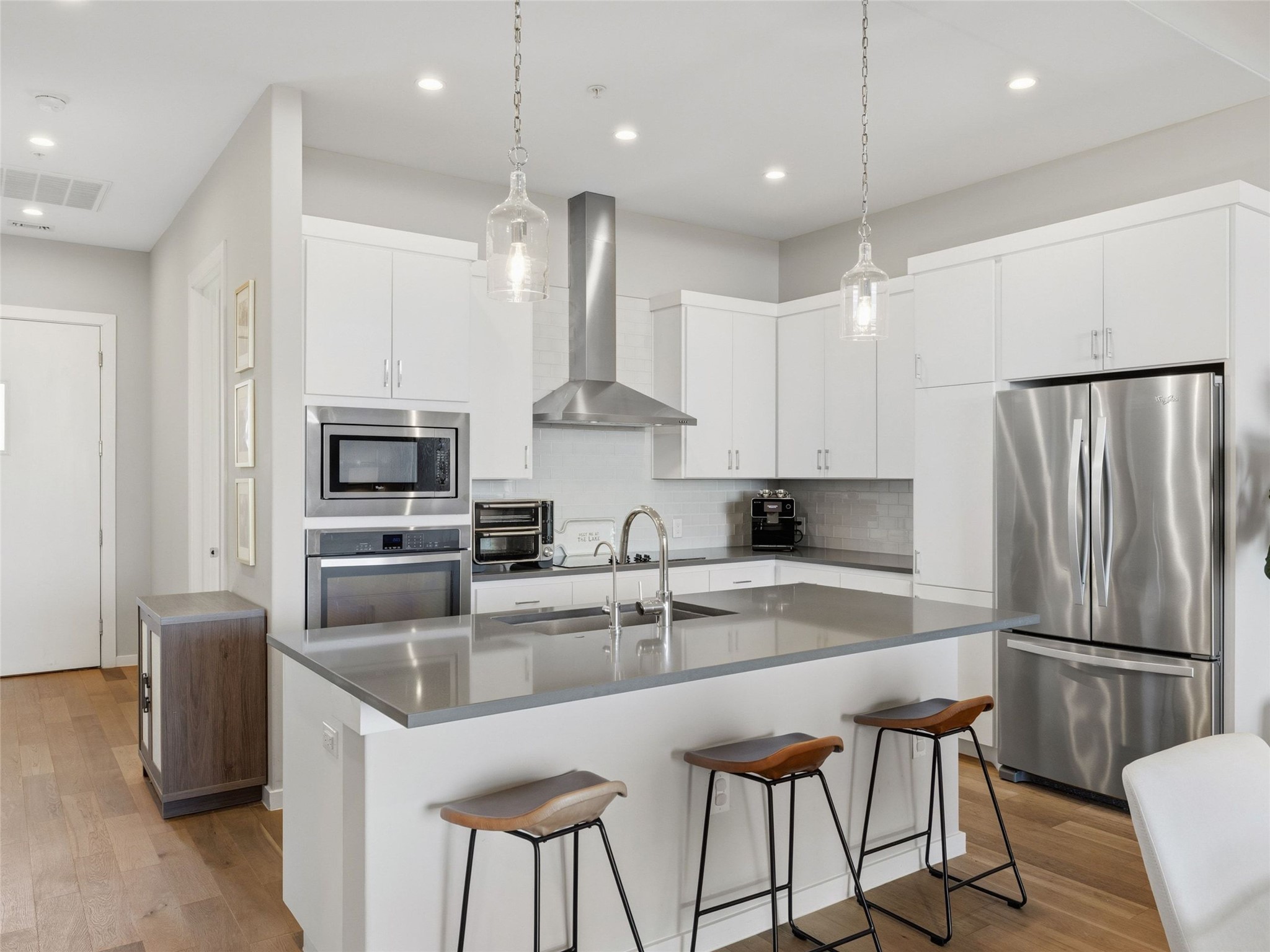 5921 Hiline Road, Unit 1303 Austin, TX 78734 - Photo 6 of 37 a kitchen with stainless steel appliances granite countertop a sink a stove a refrigerator a center island and chairs