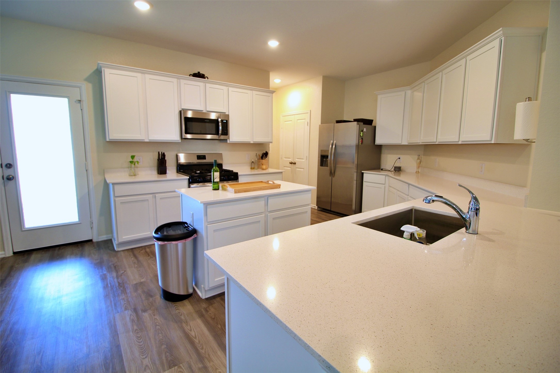 13711 Arcadia Creek Lane Rosharon, TX 77583 - Photo 11 of 24 a kitchen with a sink a stove and refrigerator