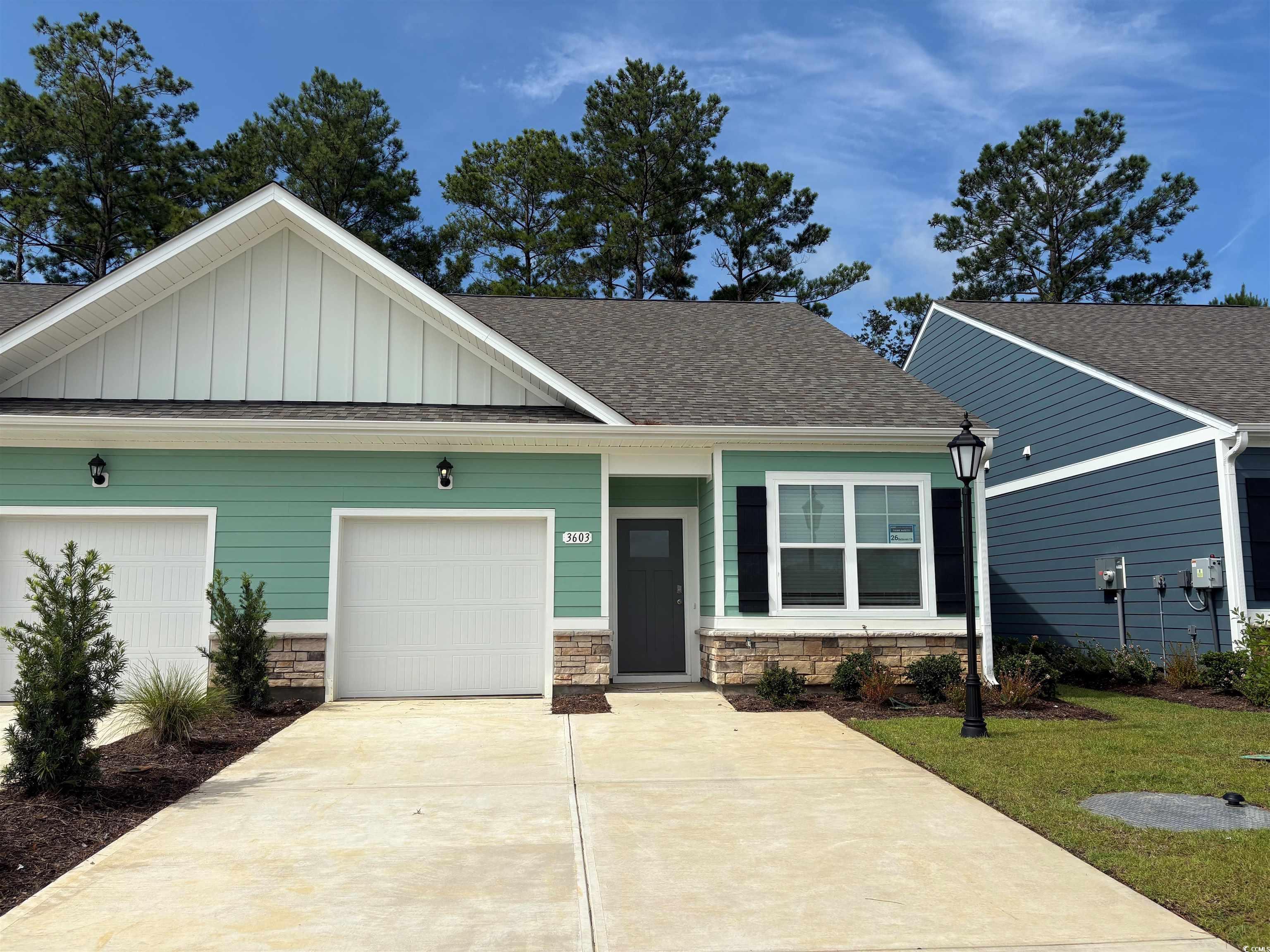 3603 Whaley Way Ash, NC 28420 - Photo 1 of 26 View of front of home featuring board and batten siding, driveway, roof with shingles, and an attached garage