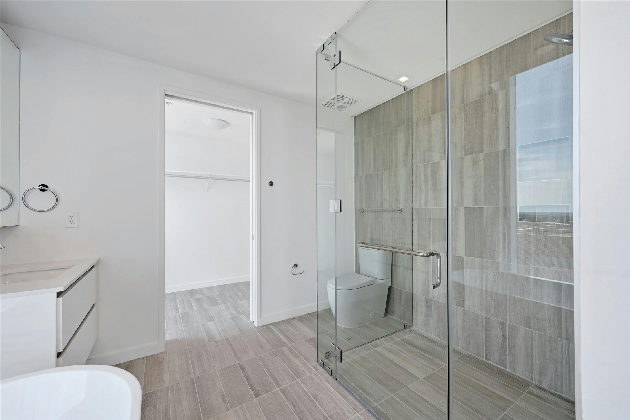 313 West 17th Street, Unit 2101 Austin, TX 78701 - Photo 9 of 36 Primary bathroom includes a frameless glass shower, and direct access to a spacious walk-in closet.
