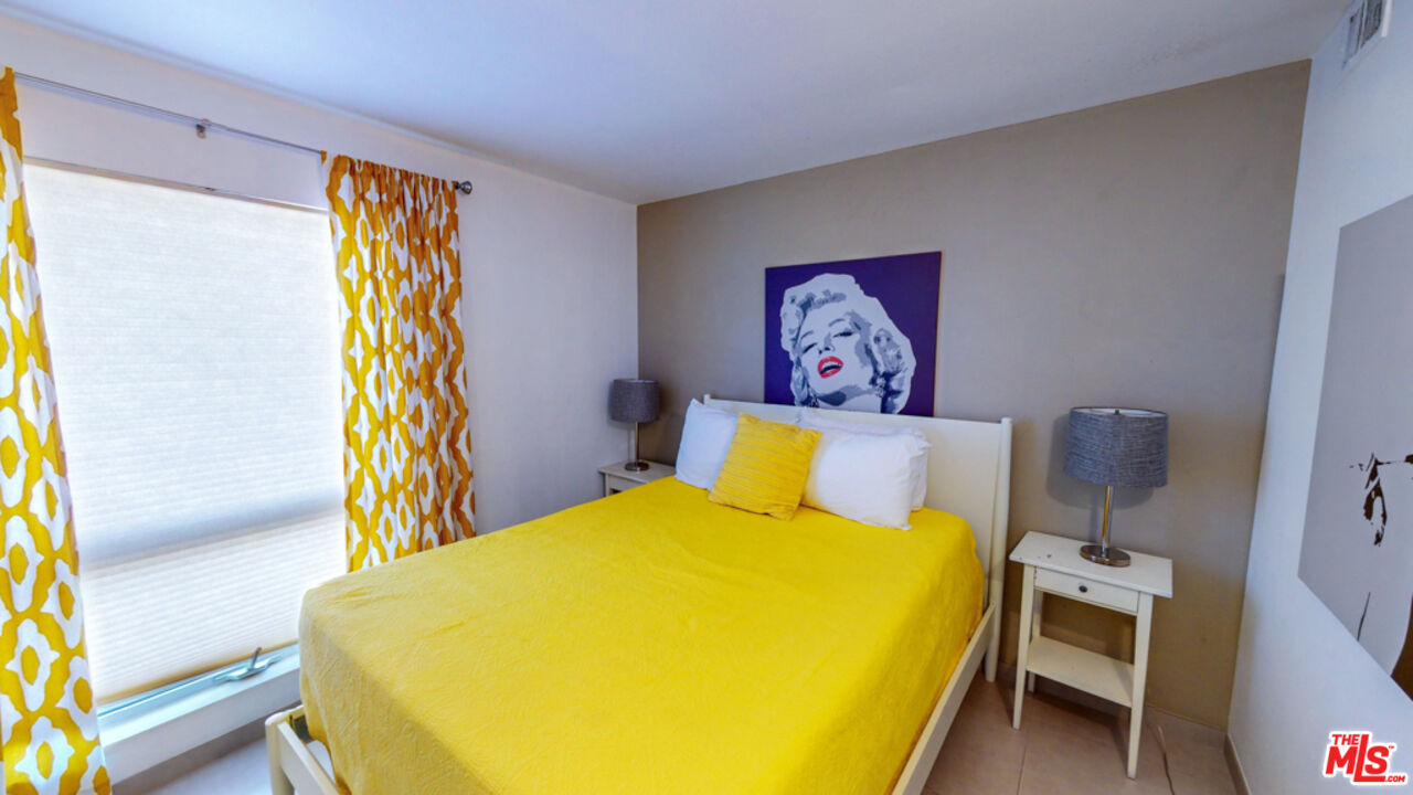 2295 East Nicola Road Palm Springs, CA 92262 - Photo 13 of 23 a bed sitting in a bedroom next to a blue wall