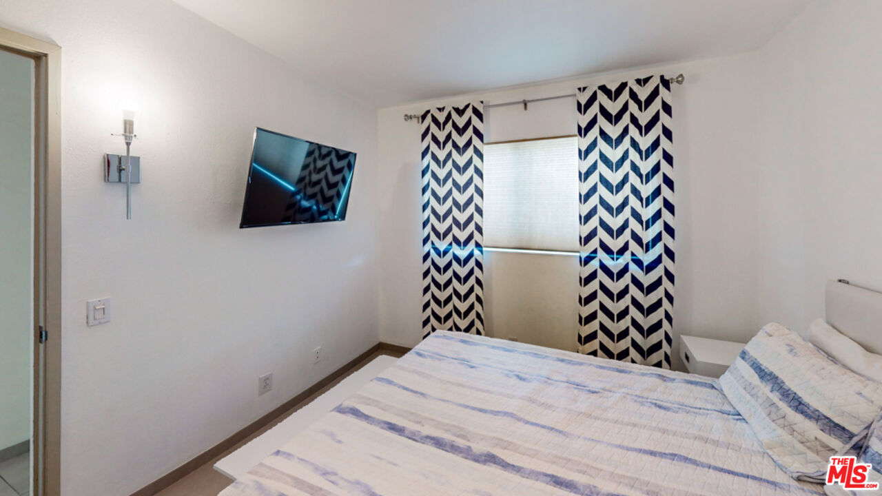 2295 East Nicola Road Palm Springs, CA 92262 - Photo 14 of 23 a bedroom with a bed and a window