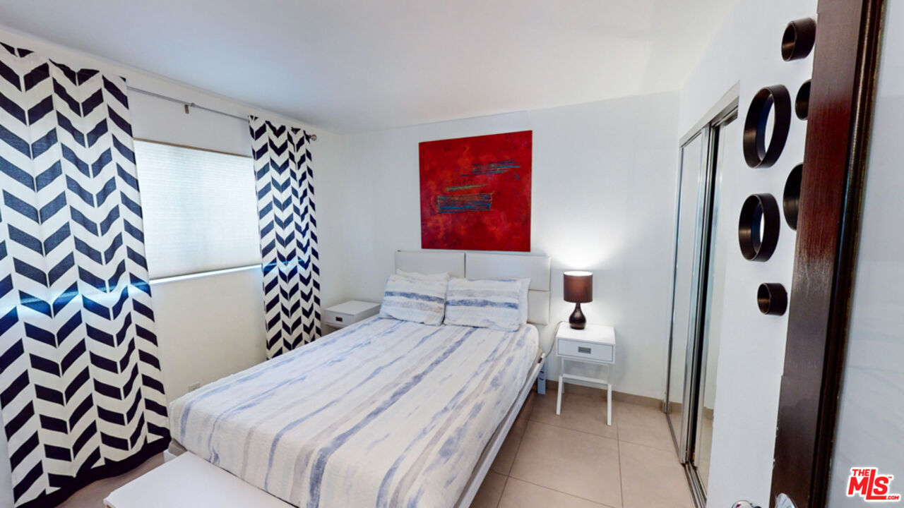 2295 East Nicola Road Palm Springs, CA 92262 - Photo 15 of 23 a bedroom with a bed and a painting on the wall