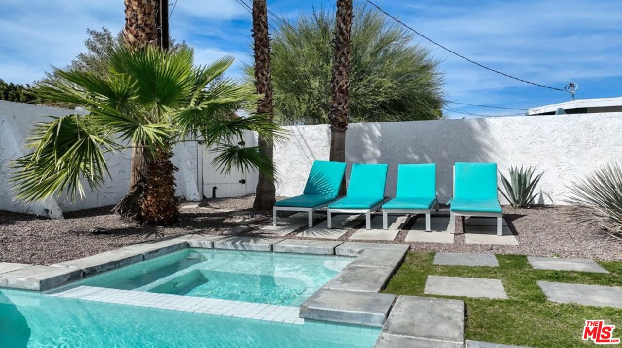 2295 East Nicola Road Palm Springs, CA 92262 - Photo 19 of 23 a view of swimming pool with outdoor seating and plants