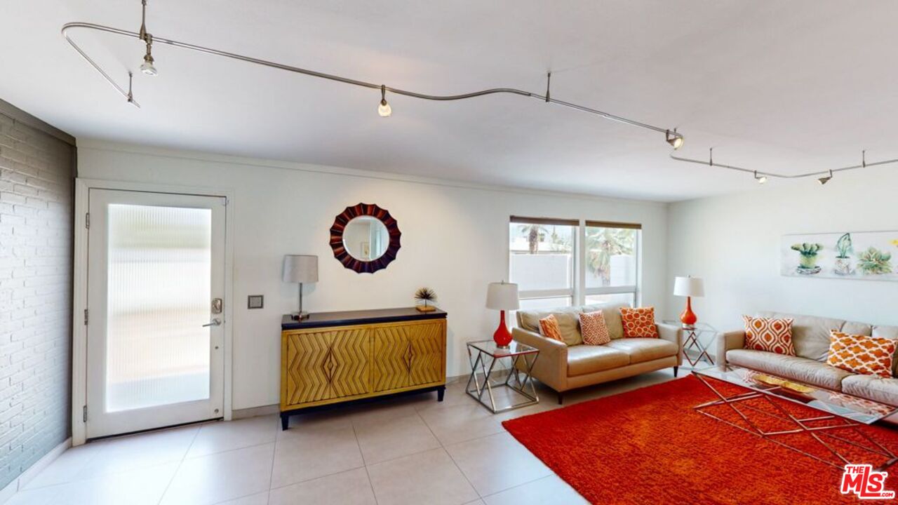 2295 East Nicola Road Palm Springs, CA 92262 - Photo 2 of 23 a living room with furniture and a window