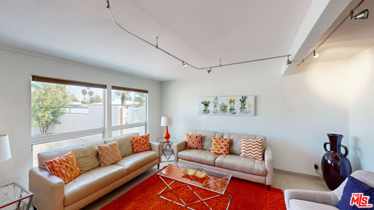 2295 East Nicola Road Palm Springs, CA 92262 - Photo 3 of 23 a living room with furniture and a large window