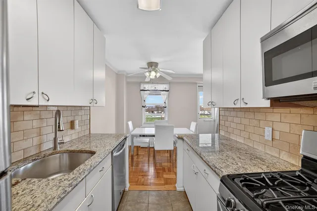 a kitchen with granite countertop a sink and a stove top oven
