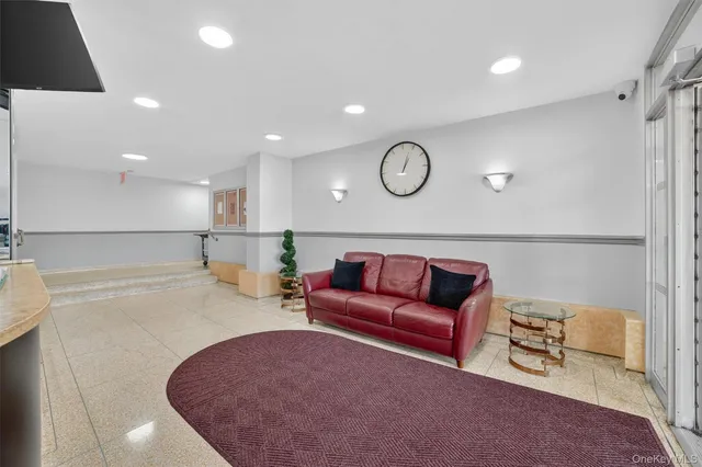 a living room with furniture kitchen view and a refrigerator