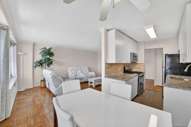 a living room with furniture a couch and a flat screen tv