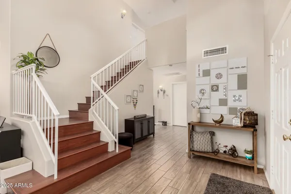 a view of an entryway with wooden floor
