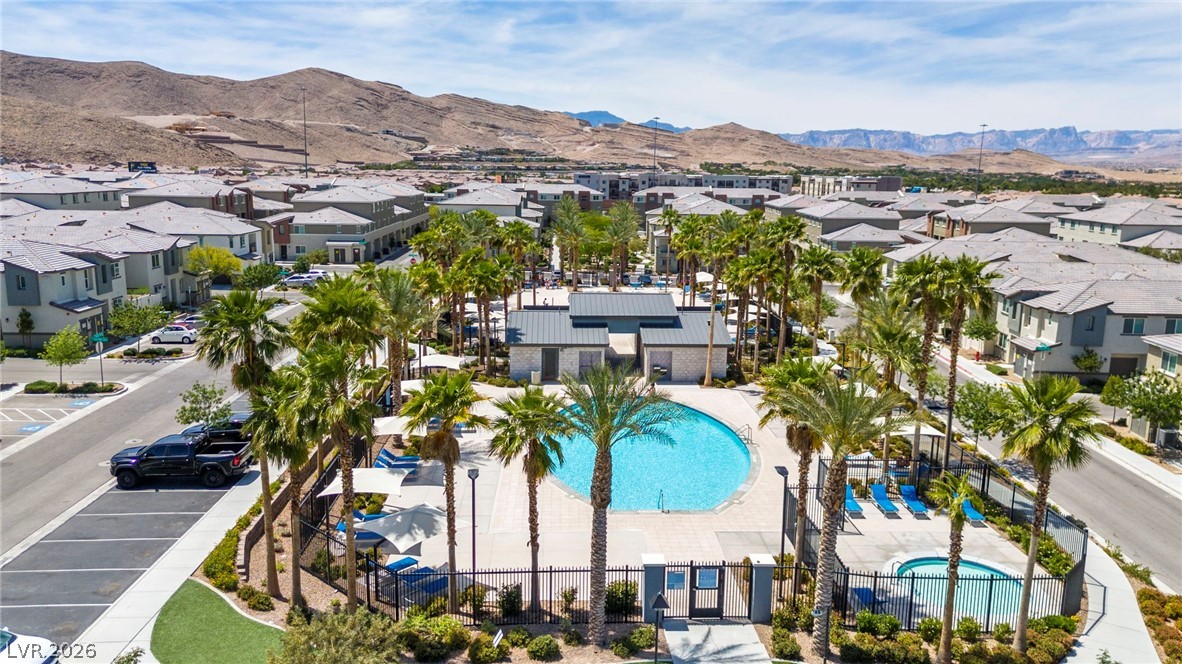 12367 Indigo Montage Road, Unit 3 Las Vegas, NV 89183 - Photo 29 of 33 An inviting community oasis with a sparkling pool awaits under a vast sky.