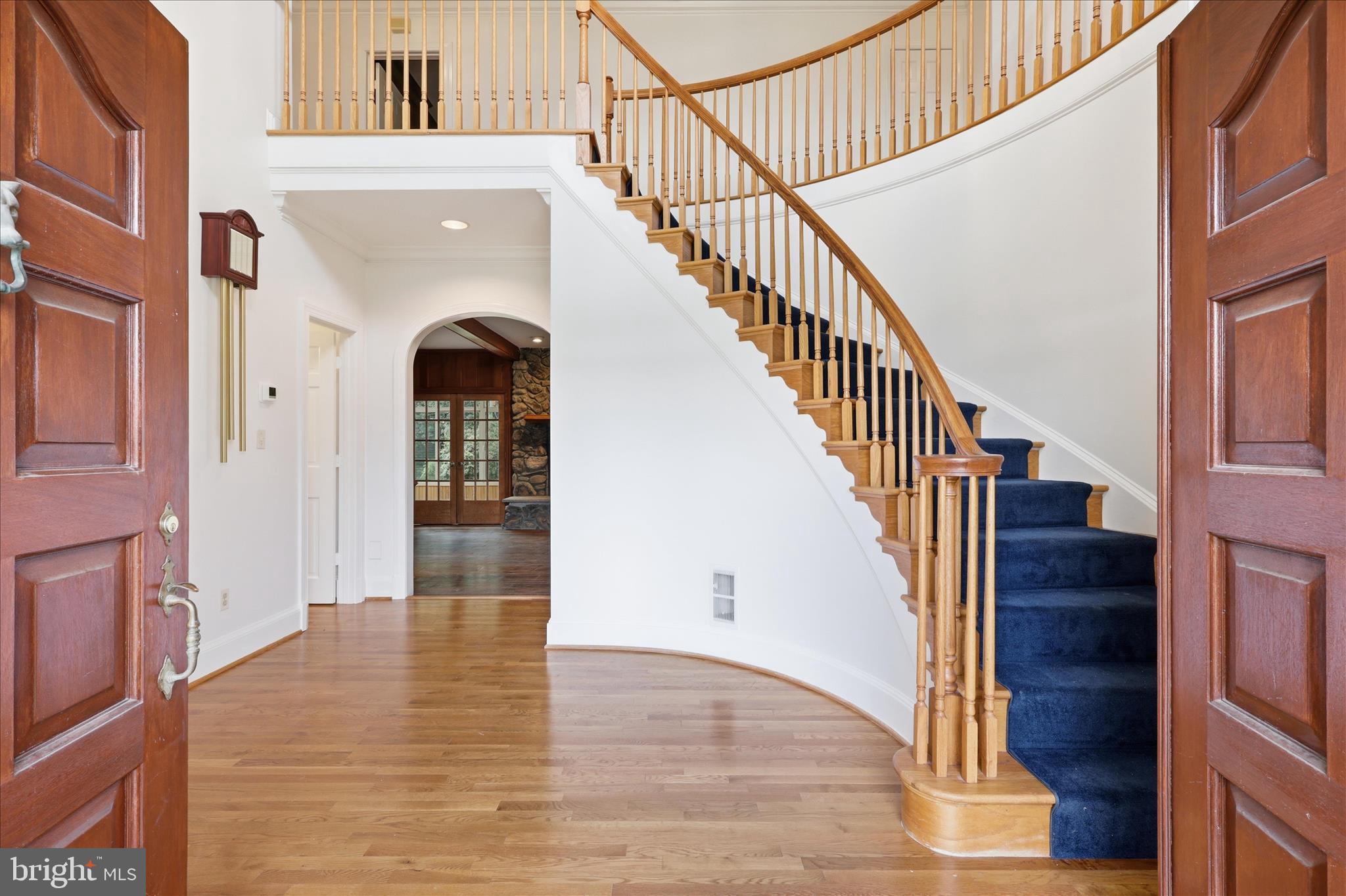 1051 Kelso Road Great Falls, VA 22066 - Photo 3 of 40 Foyer with sweeping staircase and arched doorways