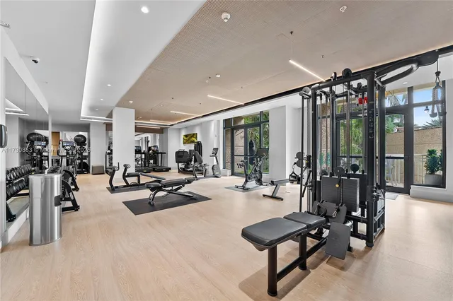 a living room with furniture and floor to ceiling window