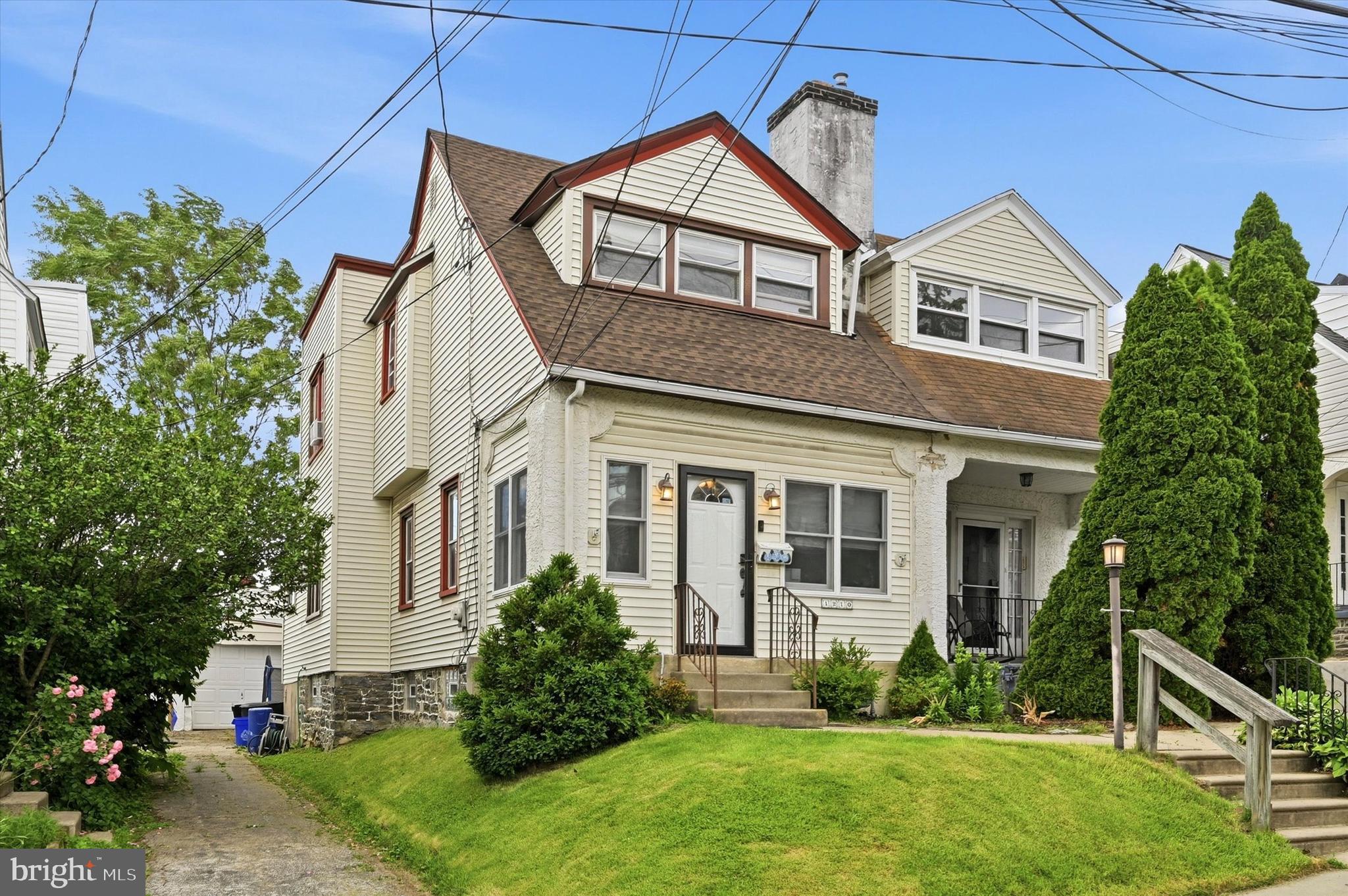 1210 Harding Drive Havertown, PA 19083 - Photo 2 of 25 a front view of a house with a yard and potted plants