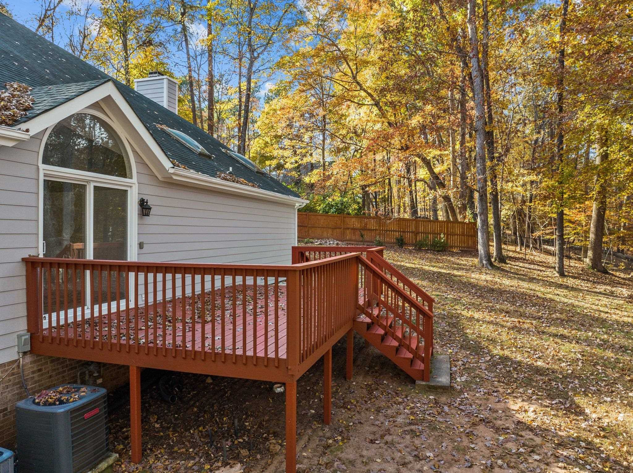 5808 Glenfiddich Way Raleigh, NC 27613 - Photo 18 of 64 a view of a roof deck with wooden fence and large trees