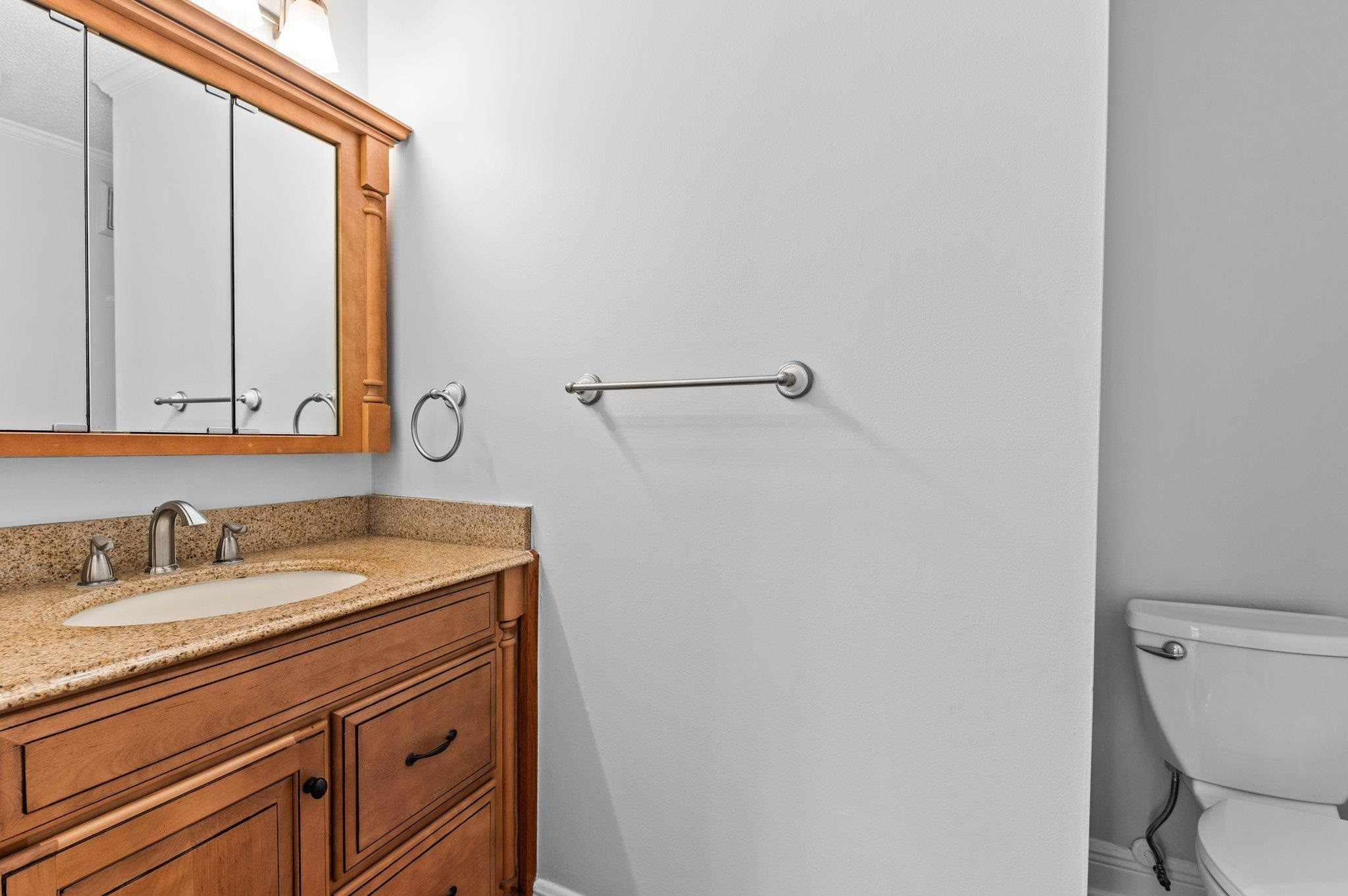 5808 Glenfiddich Way Raleigh, NC 27613 - Photo 32 of 64 a bathroom with a granite countertop sink and a mirror