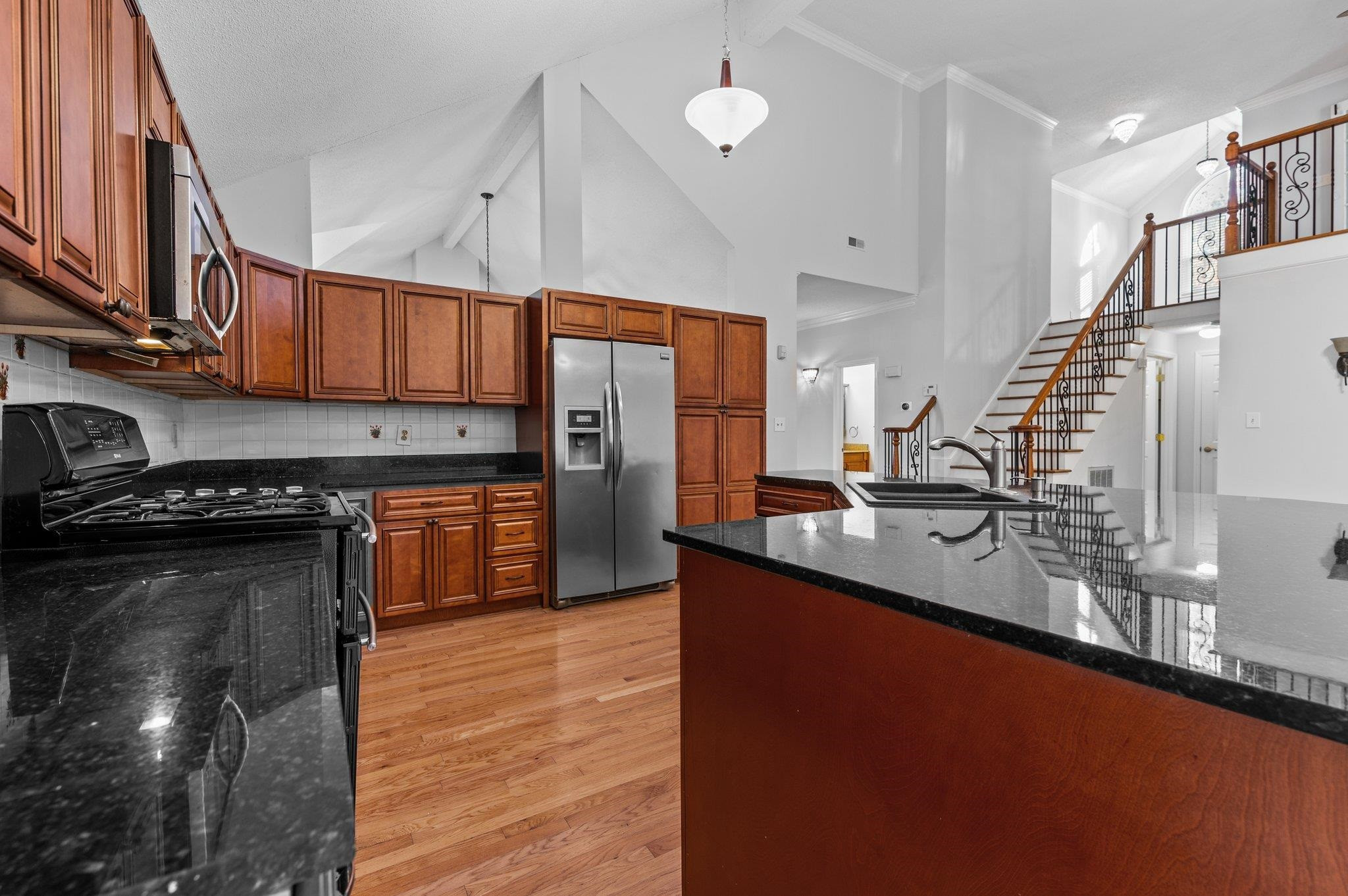 5808 Glenfiddich Way Raleigh, NC 27613 - Photo 42 of 64 a kitchen with stainless steel appliances granite countertop a sink a stove and a refrigerator