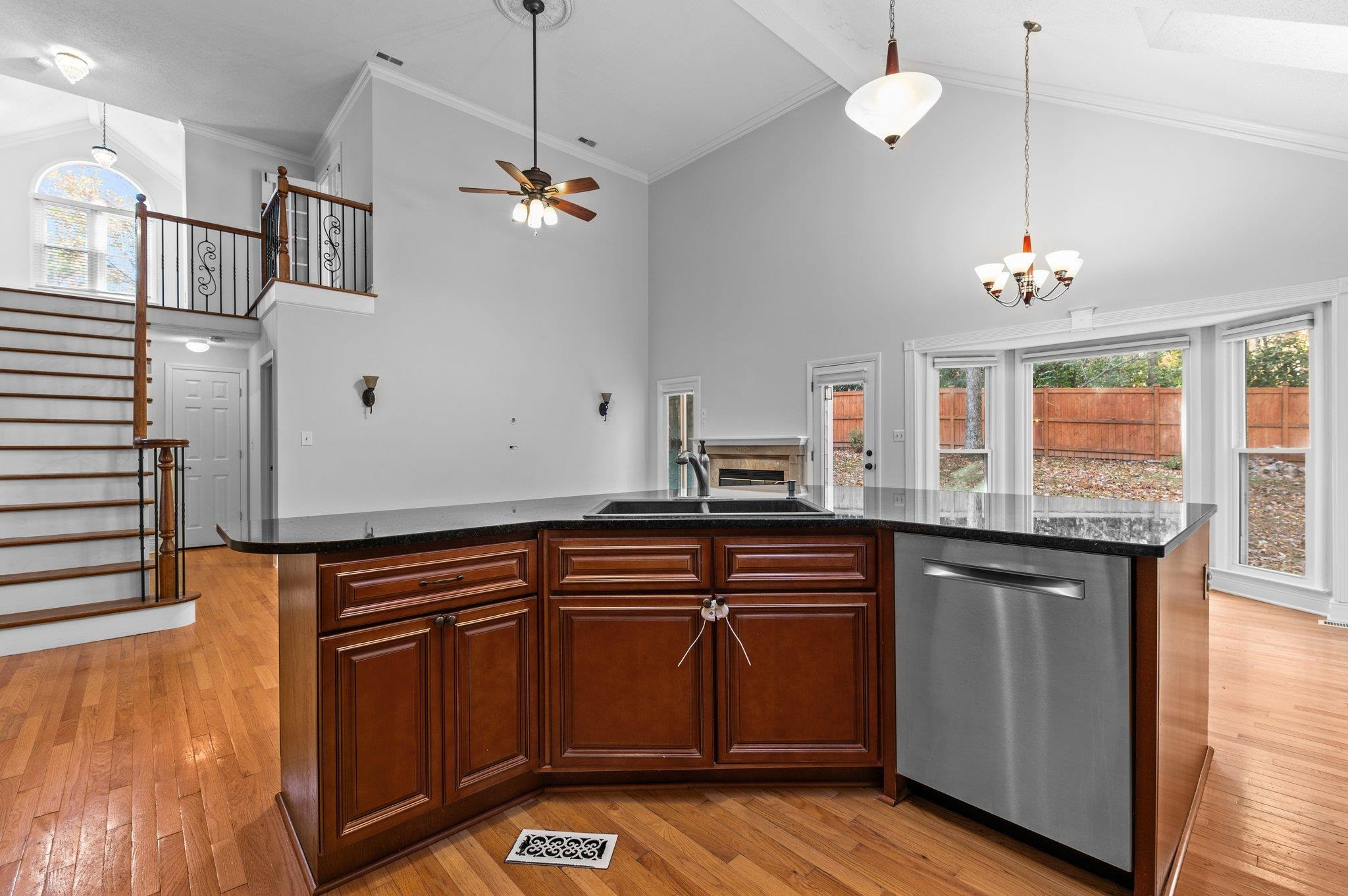 5808 Glenfiddich Way Raleigh, NC 27613 - Photo 43 of 64 a kitchen with granite countertop a sink cabinets and wooden floor