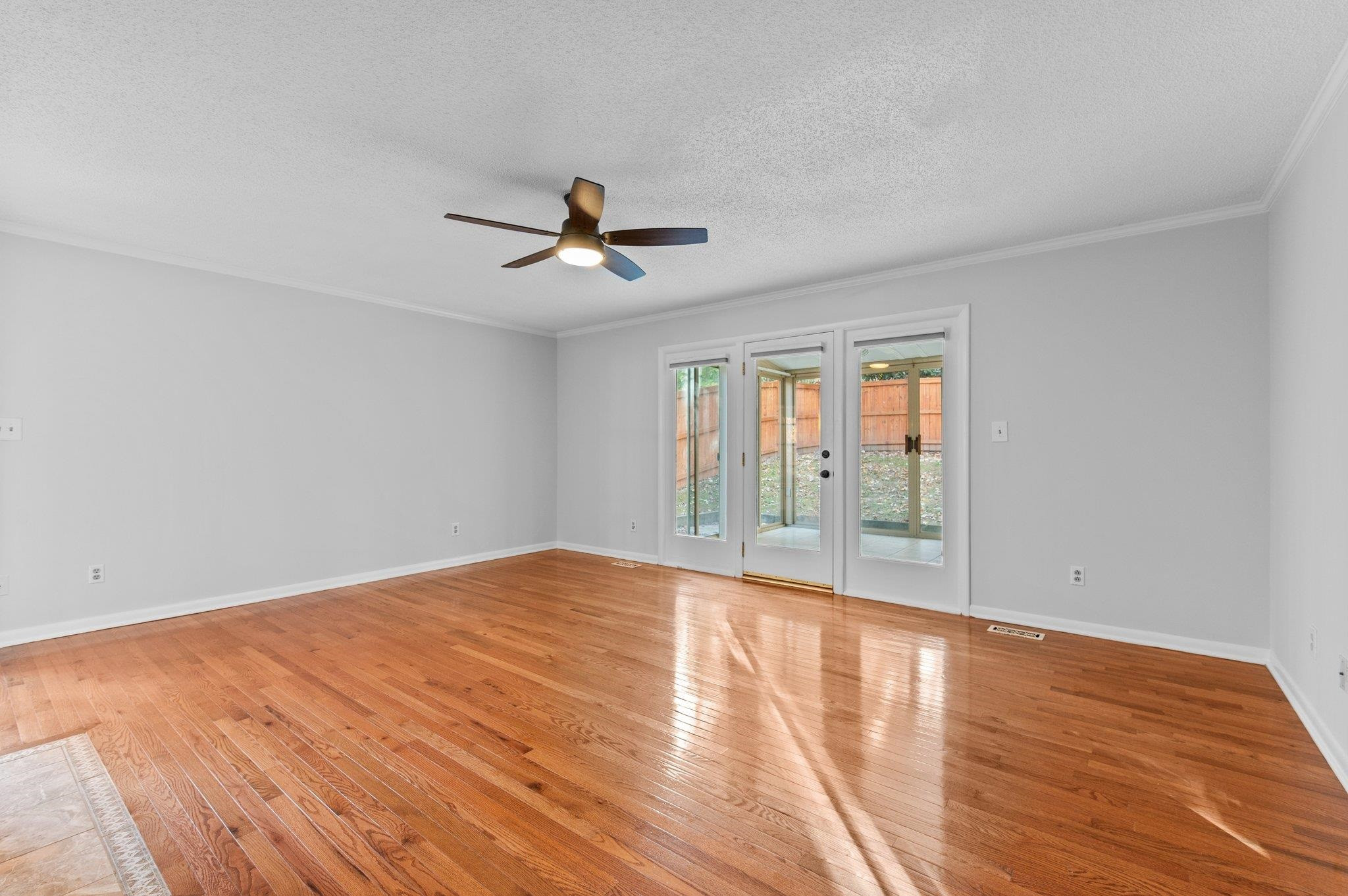 5808 Glenfiddich Way Raleigh, NC 27613 - Photo 46 of 64 a view of empty room with wooden floor and fan