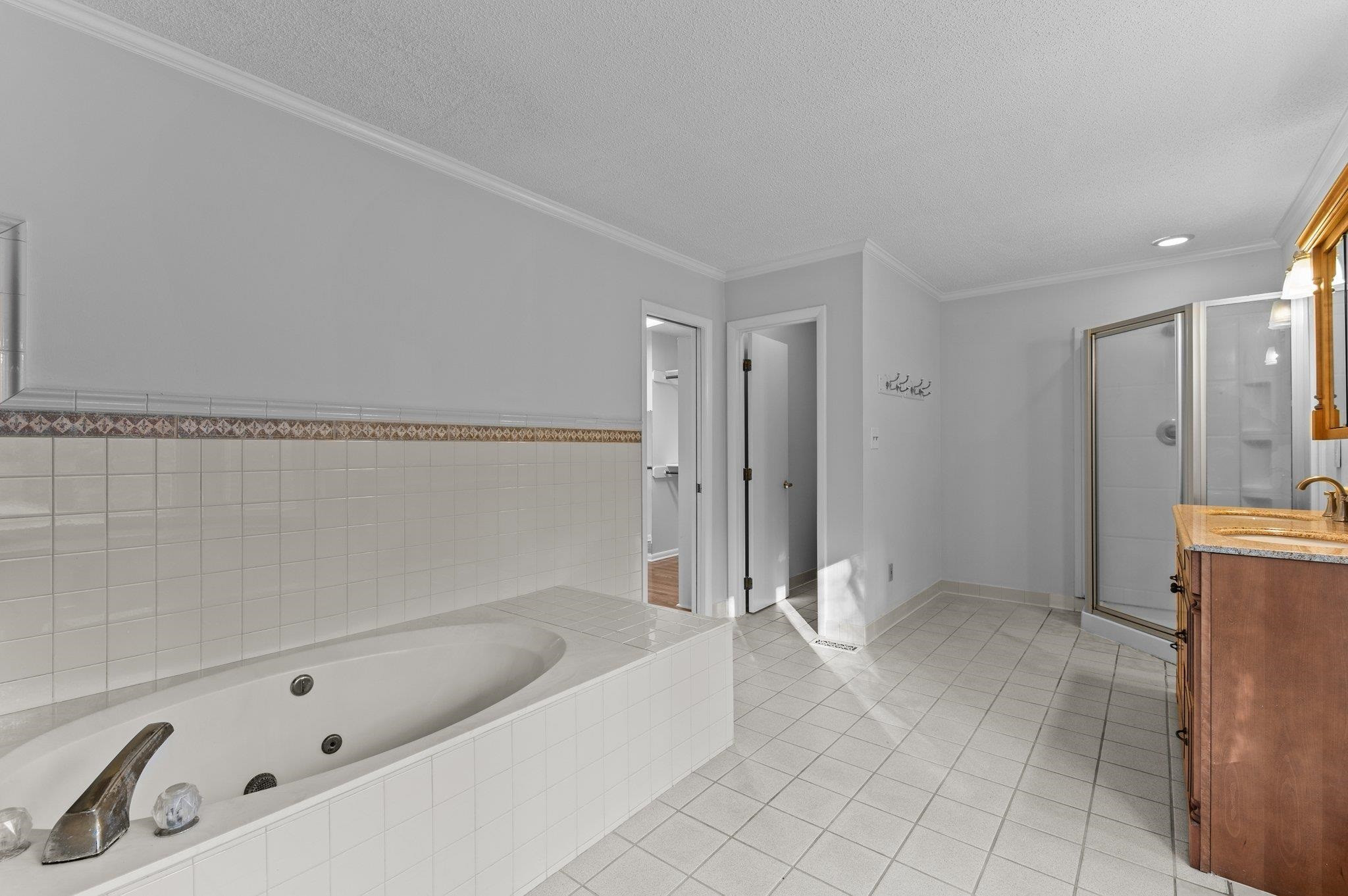 5808 Glenfiddich Way Raleigh, NC 27613 - Photo 50 of 64 a bathroom with a tub a sink and a shower