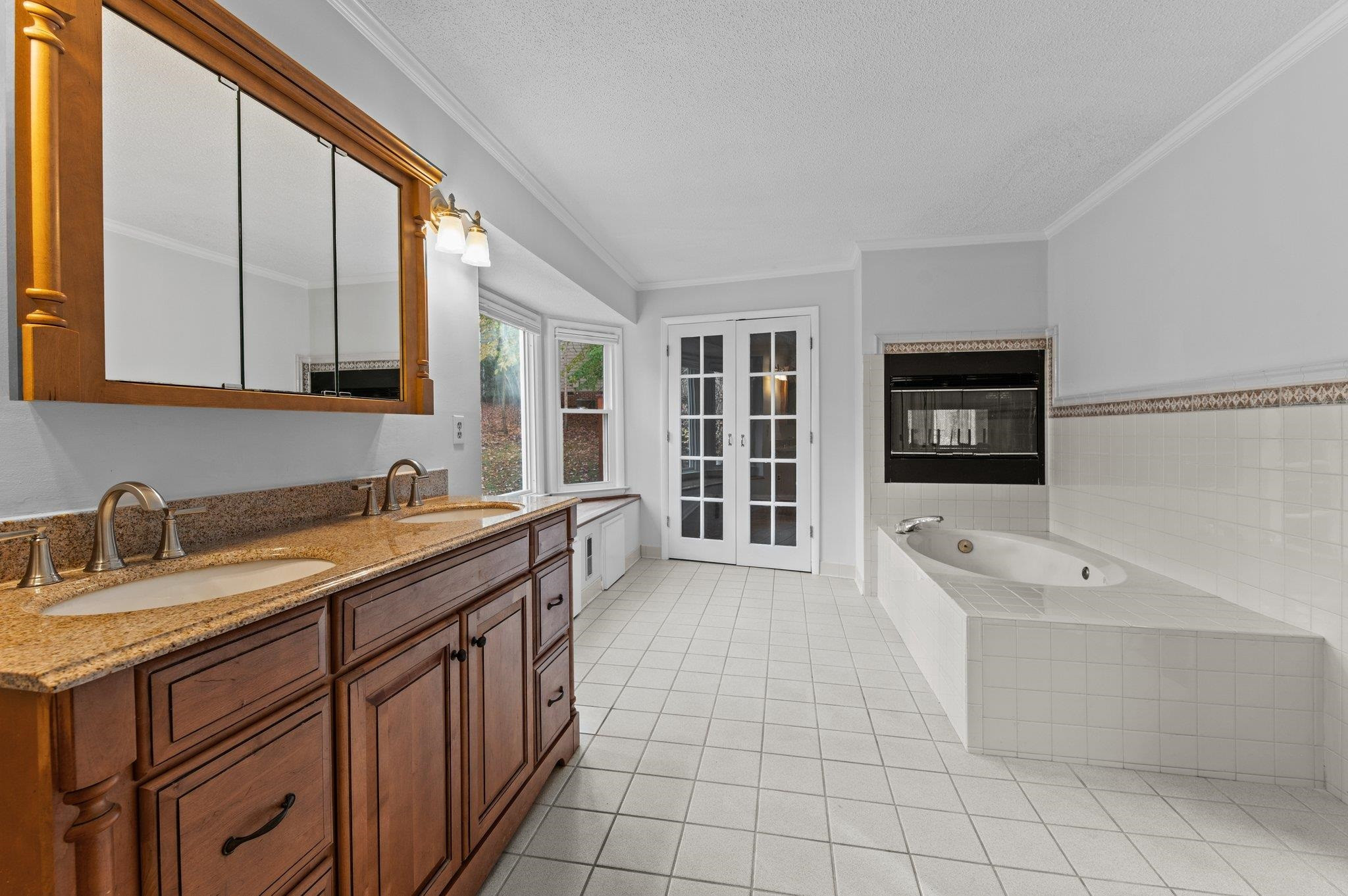 5808 Glenfiddich Way Raleigh, NC 27613 - Photo 52 of 64 a spacious bathroom with a granite countertop sink mirror and bathtub