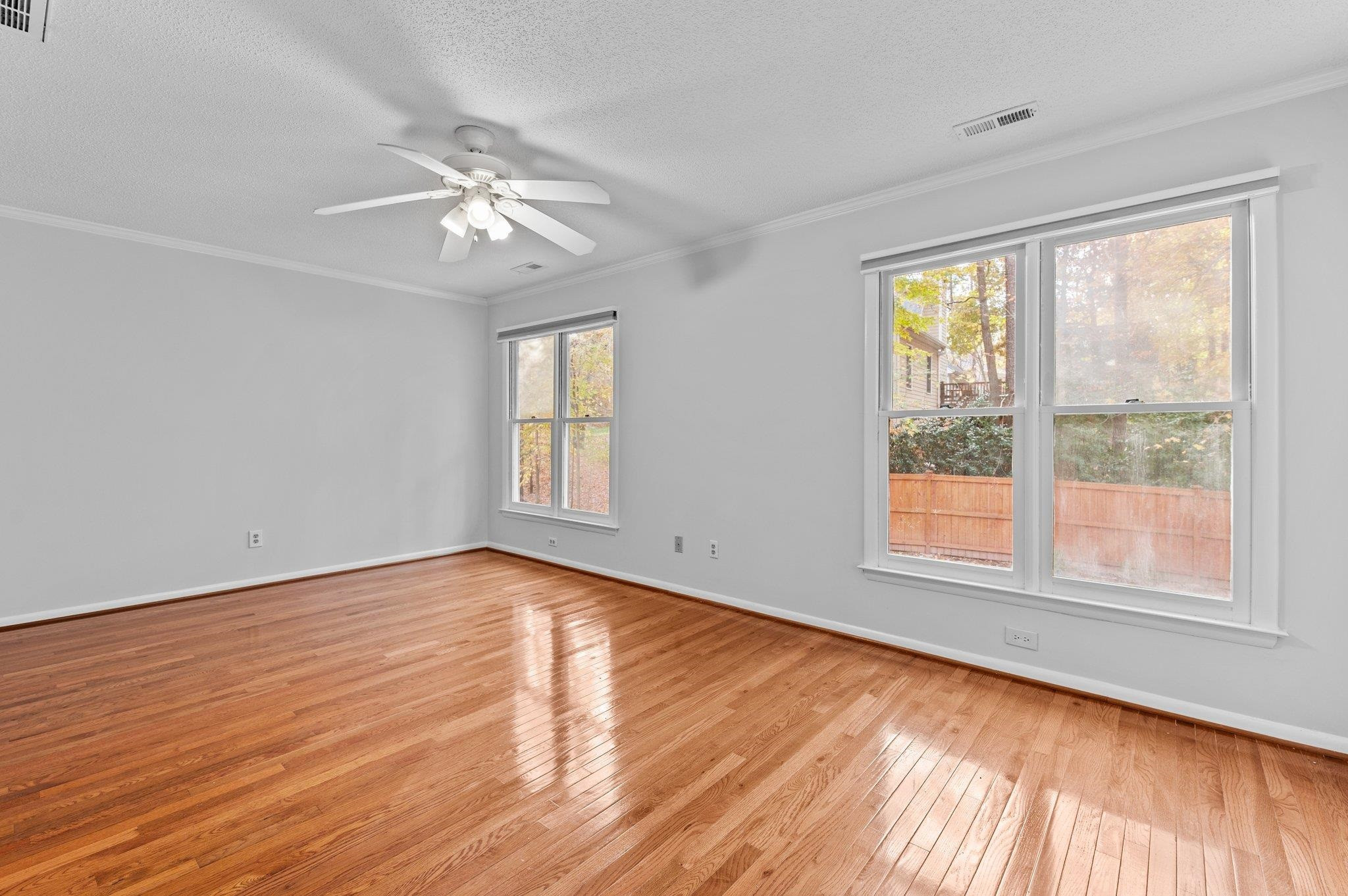 5808 Glenfiddich Way Raleigh, NC 27613 - Photo 57 of 64 a view of an empty room with wooden floor and a window