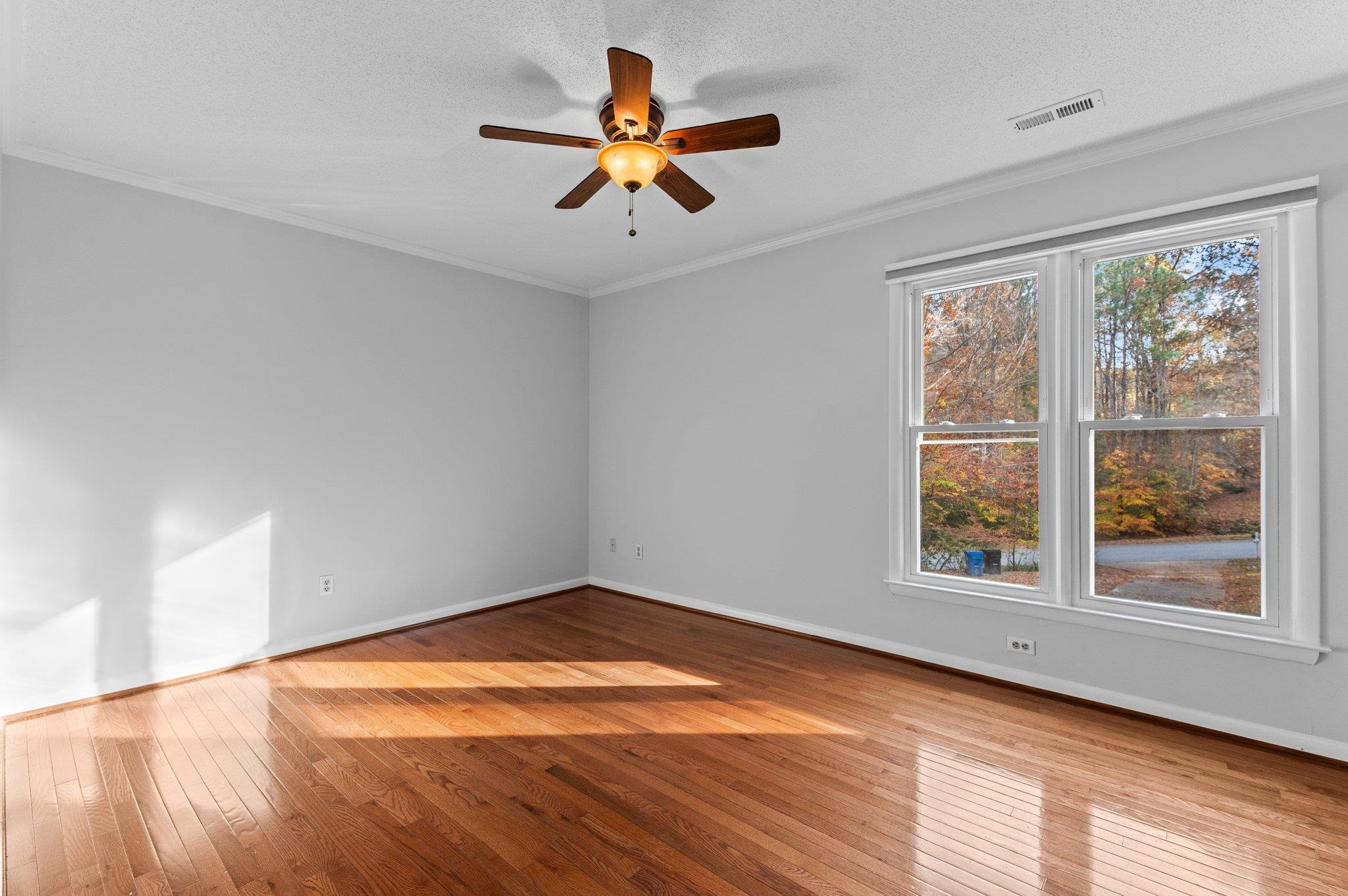 5808 Glenfiddich Way Raleigh, NC 27613 - Photo 60 of 64 wooden floor in an empty room with a window