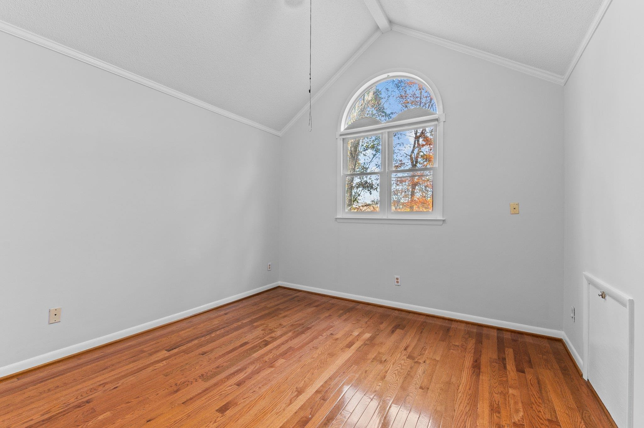 5808 Glenfiddich Way Raleigh, NC 27613 - Photo 62 of 64 an empty room with a wooden floor and a window