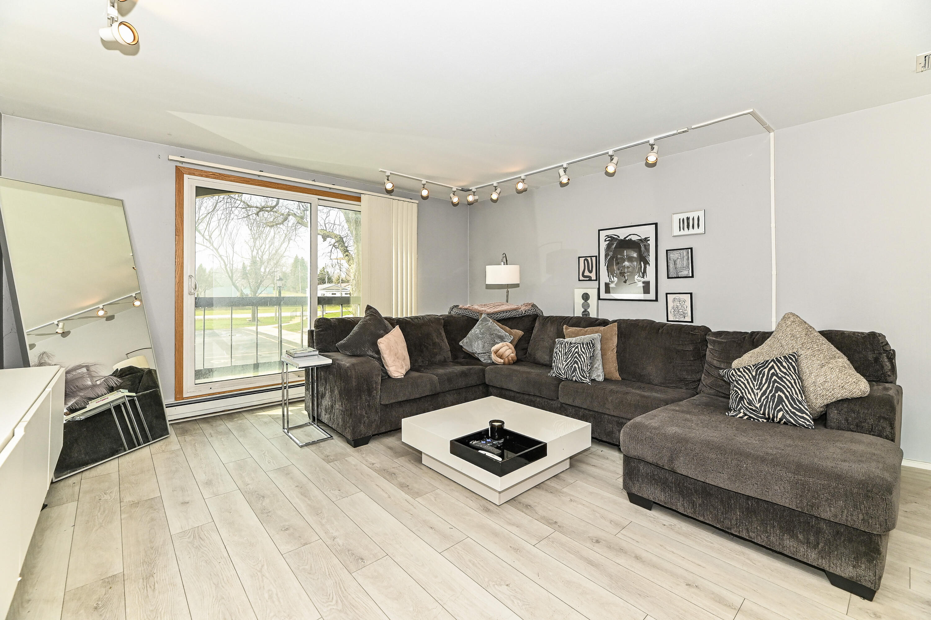 11926 West Mill Road, Unit 4 Milwaukee, WI 53225 - Photo 4 of 34 Large Living area, seller has large furniture and there is still plenty of space.