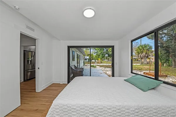 a large bedroom with a bed and a large window