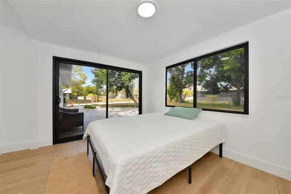 a bed sitting in a bedroom next to a window