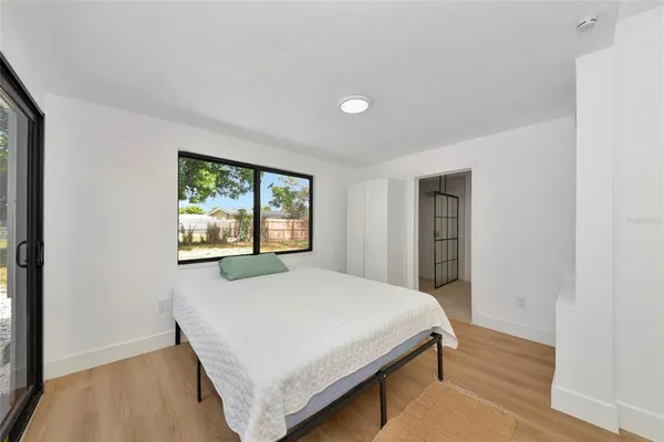 a bedroom with a bed and a window