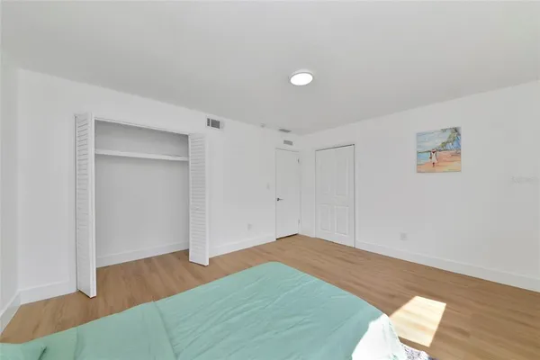 a view of a room with wooden floor and white walls