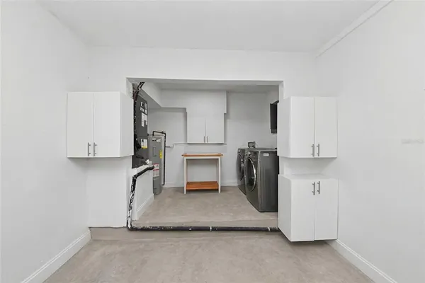 a view of kitchen with refrigerator and window